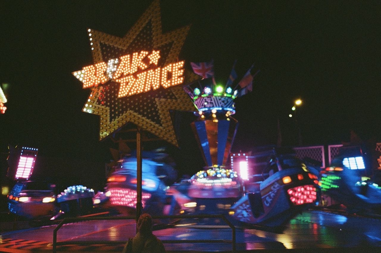 A photo of a carnvial ride called Breakdancer taken at night