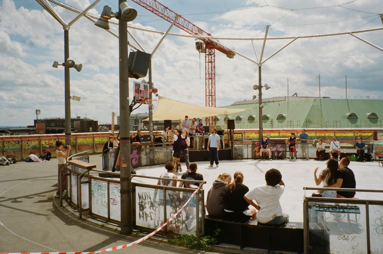 A lively scene of three people on a round basketball court